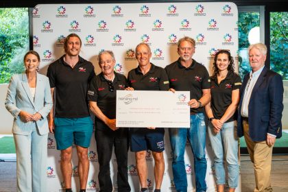 Tallebudgera SLSC team members accept a Community Fund cheque at Donation Day 2025 to support their youth surf boat and lifesaving development program.